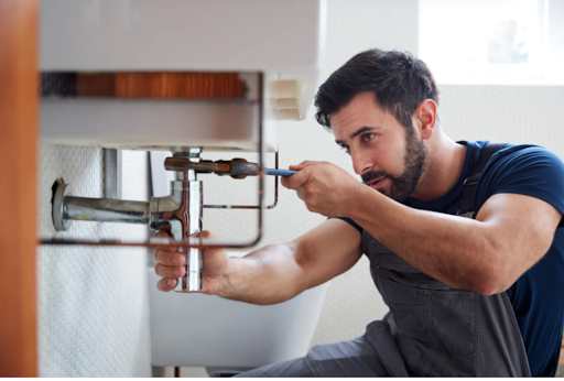 a man using a tool on a faucet pipe