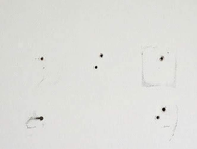 drywall holes from hanging pictures and shelves