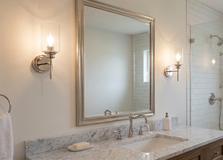 wall sconces beside a bathroom mirror